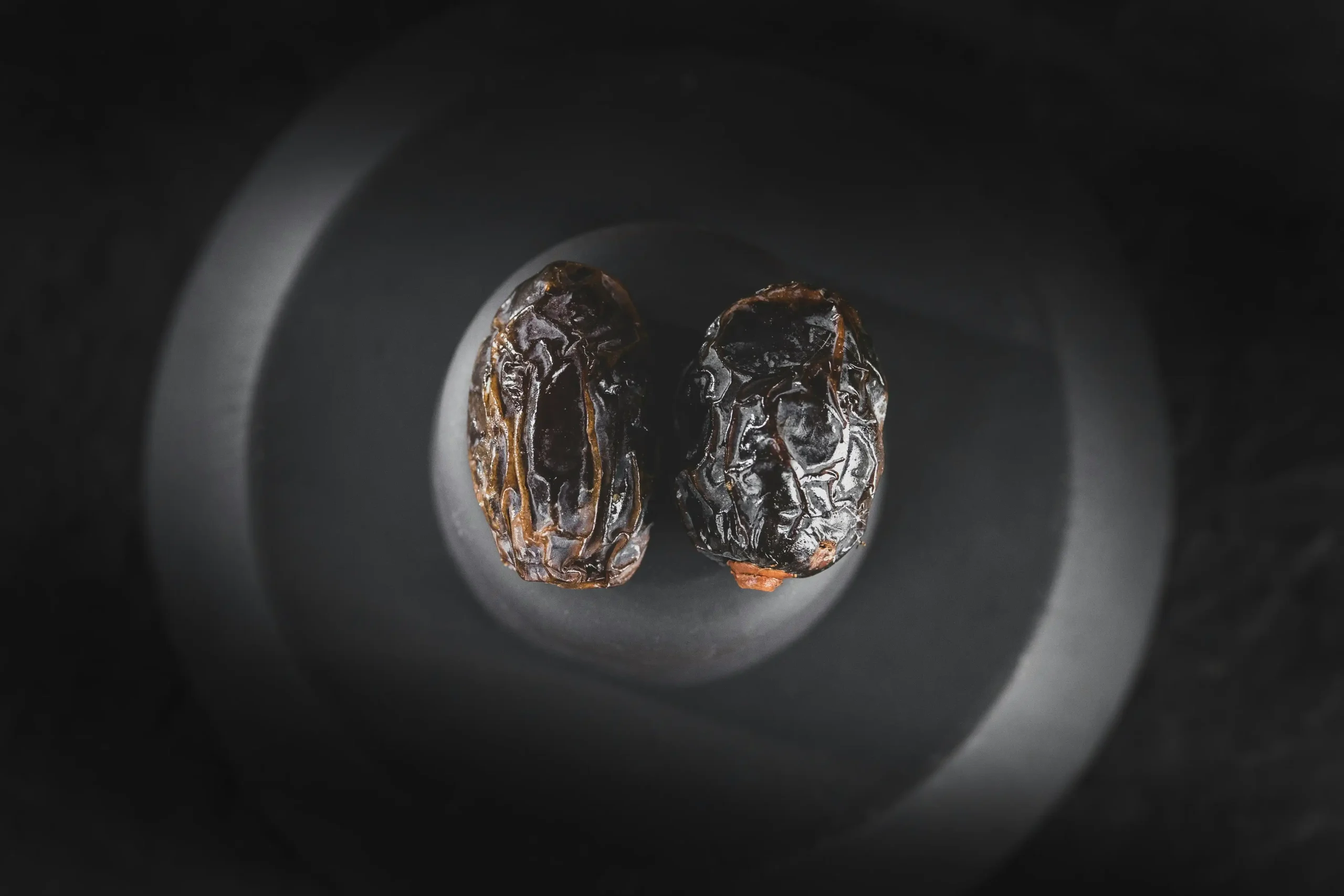 Close-up of IRANIAN dates on a dark background."